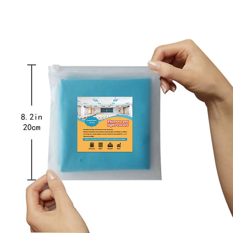 Hands holding packaged 4 Pack Fluorescent Light Covers 4 By 2 Feet Magnetic Attachments Tranquil Blue Easy Install Flame Retardant Fabric