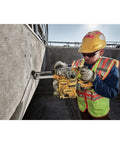 Worker using Heavy Duty Cordless 20V Brushless Rotary Hammer Drill Sick Power Bad Boy for concrete drilling on site.