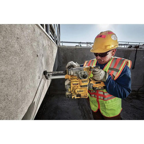 Worker using Heavy Duty Cordless 20V Brushless Rotary Hammer Drill Sick Power Bad Boy for concrete drilling on site.