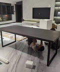 Damn Slick Matte Black Industrial Table Legs Built Tough With Solid Steel Frame For Heavy Duty Diy Coffee Or Dining Desk Projects That Hits Different On Modern Rustic Vibes For The Home, with a long black tabletop being assembled.