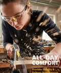 Person wearing Four Pack ANSI Z87.1 Safety Glasses with clear lenses and yellow temples, using a saw in a workshop.