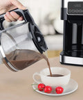 Pouring coffee from the coffee pot of the Top Shelf Automatic Drip Coffee Maker And Espresso Brewer For Home Office.
