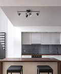 Walton 4-Light Integrated LED Track Lighting System in Matte Black, Center Swivel Bar in modern kitchen setting.