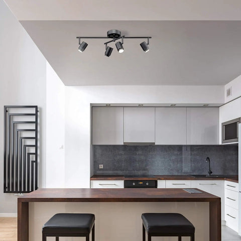 Walton 4-Light Integrated LED Track Lighting System in Matte Black, Center Swivel Bar in modern kitchen setting.