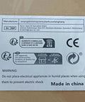 Warning label on packaging with recycling symbols, manufacturer details, and electrical safety warning, Made in China.