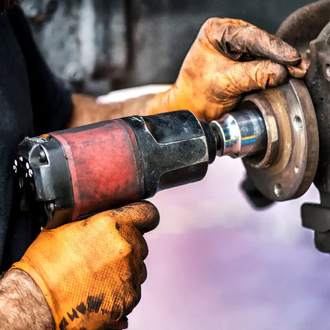 Person using a tool wearing Orange Nitrile Work Gloves Diamond Grip Eight Mil Thick Case Of Nine Hundred Extra Large Powder Free Latex Free Build.