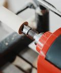 Close-up of BMWOOD 4-prong spring-loaded spur drive center, 2MT shank and 1-inch diameter, gripping light wood on a wood lathe.