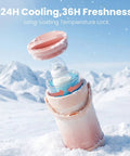 Portable Breast Milk Storage Bottle Smart Temperature Display 20 Oz Insulated Chiller Pink in snowy landscape, with lid open and milk visible.