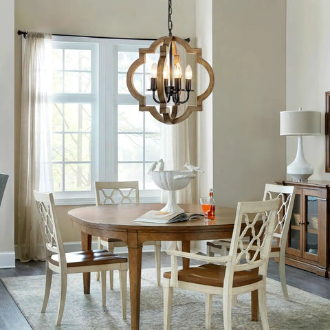 Rustic 4 Light Orb Chandelier Handcrafted From Solid Wood With Black Metal Details hanging in a dining room above a wooden table and chairs.