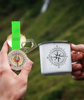 Trail Ready Thumb Orienteering Hiking Compass With Quick Reset Needle Pocket Size For Outdoor Navigation And Backpacking Adventures Waterproof Durable Acrylic Shell Great For Hiking Camping Trails And Backcountry Travel held beside a compass-themed mug