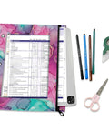 Colorful zippered coupon binder case for school and office use with pink purple teal accent, laid with stationery items.