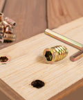 5/16-18 Threaded Inserts For Wood Nutserts For Furniture Screw-In Nut 25mm Length Hex Drive displayed on wooden board with tool