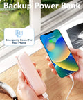 Person holding pink power bank charging a smartphone on wooden table with window view, labeled 'Emergency Power For Your Phone'