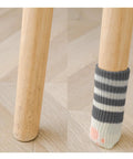 Comparison of chair leg without and with 4 Pack Paw Design Furniture Socks For Killer Noise Reduction in Dark Grey.