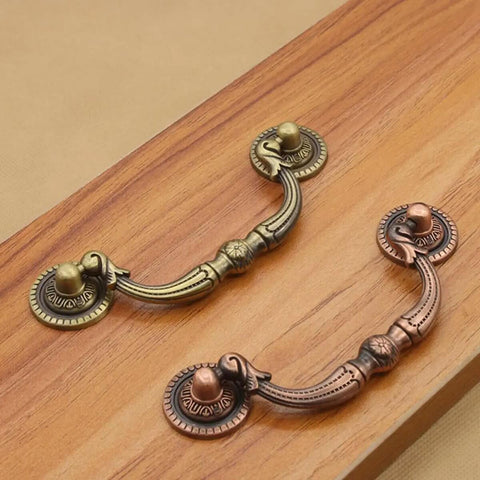 Two Pack Retro Drop Pendant Drawer Pulls Cabinet Handles Antique Style With Vintage Vibe Knobs And 9.6cm Hole Spacing displayed on wood