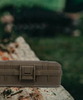 Tough As Nails Heavy Duty Plastic Toolbox With Interlocking Stackable Design And Thick Three Layer Foam Cushioning For Job Site Ready Water Resistant Gear Storage And Drop Safe Protection on tree stump.
