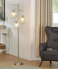 Industrial Rustic Floor Lamp With Three Teardrop Cage Shades Tall Modern Standing Light For Living Room And Home Office Minimalist Chrome Pole Lamp With Edison Style Bulbs Included in corner next to chair