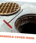Badass Heavy Duty Steel Manhole Cover Lifter Hook Built With A Nifty T Handle To Safely Hoist Storm Drain Grates During Quick Yard And Property Maintenance Tasks, shown beside an open storm drain.