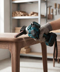 Heavy Duty Cordless Belt Sander Built Like A Workhorse With Brushless Motor And 18V Battery Fit For Fast Rust Knockout And Smooth Wood Polish On Any Garage Build being used on a wooden table surface.