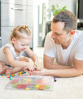 Father and child playing with toys next to an Eight Piece Zipper Pouch Set With Eight Sizes And Eight Colors For Grab And Go Organizing