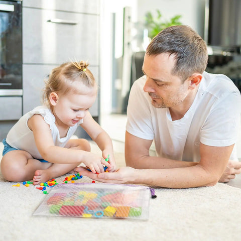 Father and child playing with toys next to an Eight Piece Zipper Pouch Set With Eight Sizes And Eight Colors For Grab And Go Organizing