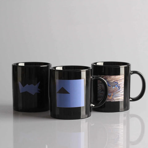 Three black mugs with custom designs using Water Slide Decal Paper For Inkjet Printers Clear US Letter Size 8.5 By 11 20 Sheets.