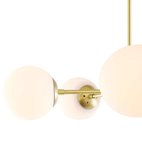 Close-up of Grammercy 5 Light Chandelier Pendant In Brushed Brass With White Frosted Globes showing metal frame and globes