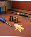 Retro Golden Metal Duckbilled Hasp Lock Toggle Latch Set Replaces Worn Hardware For Tool Chests Jewelry Boxes and Wooden Trunks With Zinc Alloy Fastener On Workbench With Tools
