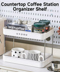 Coffee Bar Organizer Station With 2 Tier Mug Rack And Removable Drain Tray on kitchen countertop with mugs and coffee pods.