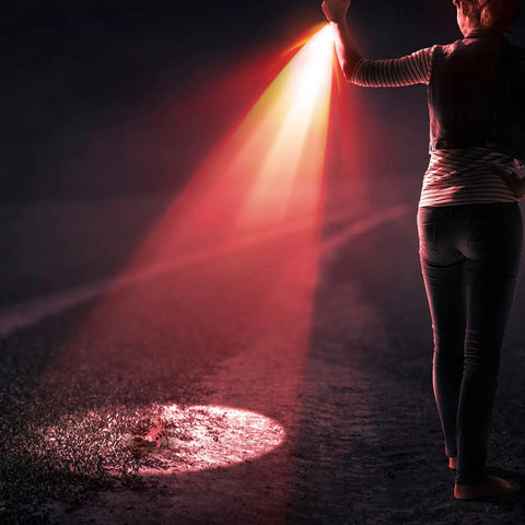 Person using Red Light Flashlight With One Mode LED Torch Scalable Red Lens Filter for hiking at night illuminating the path