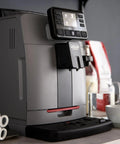 Automatic Espresso And Over Ice Coffee Maker With Professional Auto Milk Frother For Bold Iced Refreshers And Daily Grind Dominance In Sleek Moonlight Grey on countertop with cups.