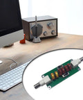 Desktop setup with 20m 30m 40m CW Low Pass Filter For Radio And TV Broadcasting Cranks Up Crystal Clear Audio And Cuts Out Unwanted Frequencies With 7 MHz 10 MHz And 14 MHz Range For Pristine Signals on a wooden surface and a vintage radio nearby.