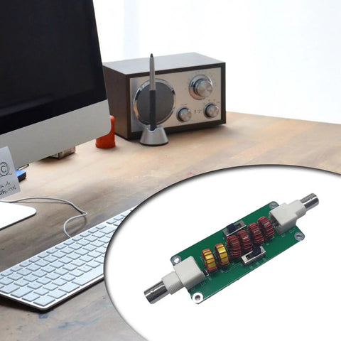 Desktop setup with 20m 30m 40m CW Low Pass Filter For Radio And TV Broadcasting Cranks Up Crystal Clear Audio And Cuts Out Unwanted Frequencies With 7 MHz 10 MHz And 14 MHz Range For Pristine Signals on a wooden surface and a vintage radio nearby.