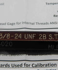 Close-up of Certified 3/8-24 UNF 2B STI Helicoil Thread Plug Gauge markings on metal tool.