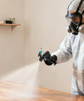 User spraying with Heavy Duty PU Foam Spray Gun With Air Purge And Slick Self Cleaning Point Zero Zero Four Nozzle on a wooden table.