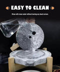Natural Granite Hand Crank Mill Grinder for Beans Grains Spices and Herbs with Wooden Frame shown mid-use with water cleaning