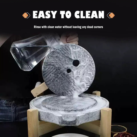 Natural Granite Hand Crank Mill Grinder for Beans Grains Spices and Herbs with Wooden Frame shown mid-use with water cleaning