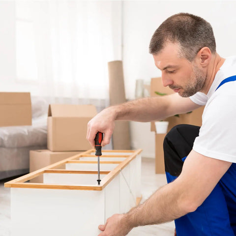 Person assembling furniture using Kickass Quality 100 Pack Black Stainless Steel Wood Screws Flat Head Phillips Drive 8 X 1 2 Inch.