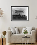 Vintage Airship Toy Model Wall Art Framed Black Wood Print in living room with beige couch and decor, museum quality archival paper.