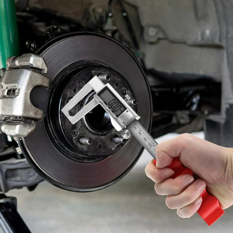 Hand using High Precision Digital Caliper For 0 To 6 Inch (0-150 MM) Stainless Steel With Large LCD Display on brake disc
