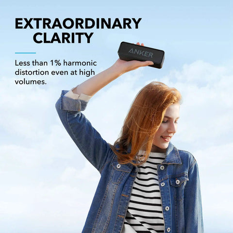 Woman holding Upgraded Bluetooth Speaker With IPX5 Waterproof, Rich Stereo Sound, Deep Bass, And 24 Hour Playtime, Your Go To Portable Wireless Speaker For iPhone, Android And More, Black outdoors against blue sky