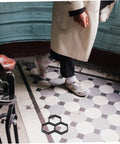 Person walking on tiled floor with DIY Hexagon Cement Floor Mold For Garden Paths And Patios Reusable Paving Mold shown.