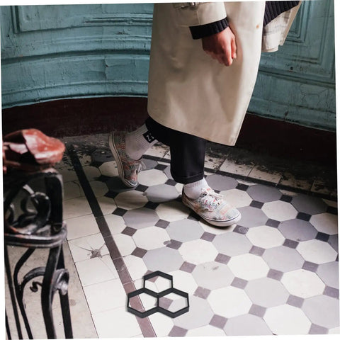 Person walking on tiled floor with DIY Hexagon Cement Floor Mold For Garden Paths And Patios Reusable Paving Mold shown.