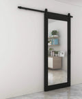 Dope Mirrored Glass Sliding Barn Door In Black MDF With Hardware Kit And Door Handle Ready To Hang Pre Finished 36 In By 84 In Interior Door With Full Size Mirror Panel For Closets Bathrooms Pantries Laundry Rooms And Bedrooms installed on white wall, full view with reflective surface.