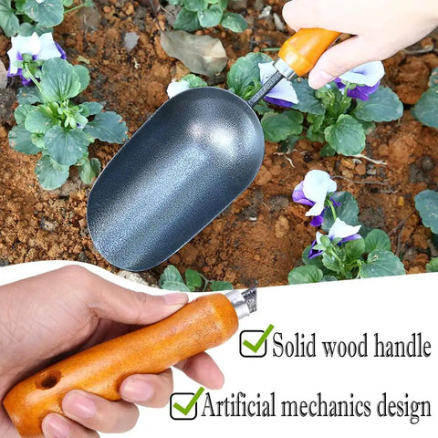 Hand holding 12.6-Inch Garden Hand Trowel With Wooden Handle And Rust-Resistant Steel Head For Transplanting Flowers
