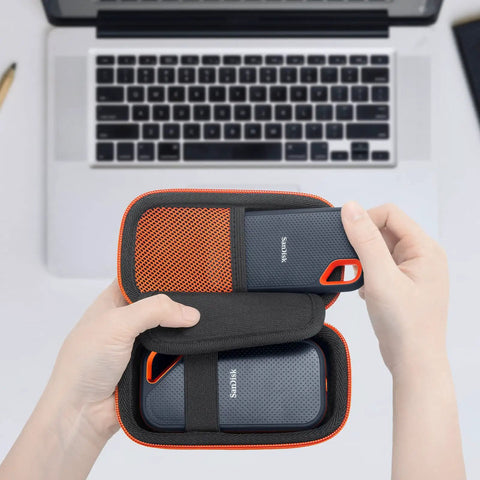 Person placing SSD into Rugged Hard EVA Case For SanDisk Extreme Pro And SanDisk Extreme Portable External SSDs, Holds Two Drives And Cables