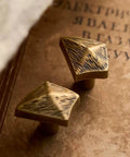Antique Bronze Cabinet Knobs And Drawer Pulls Two Pack With Boho Geometric Silhouettes on vintage book background.