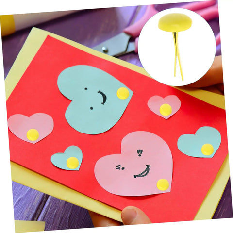 Card decorated with heart cutouts secured by yellow brads, featuring 500 Pieces Scrapbooking Paper Fasteners Brads Clip Set For Photos And Cards And Paper Crafts Durable Vintage Style Scrapbook Embellishments For Creative Journaling And Card Making.