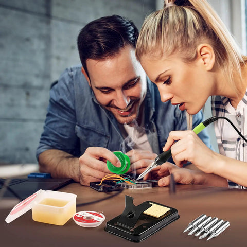 Two people using 100W LED Digital Soldering Iron Kit With Ceramic Heater, Quick 15 Second Heat Up, showing solder wire and tips.