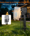 Outdoor Dusk To Dawn Stake Timer Power Hub with Six Outlets, Weatherproof Power Strip on a 6ft cord in garden setting